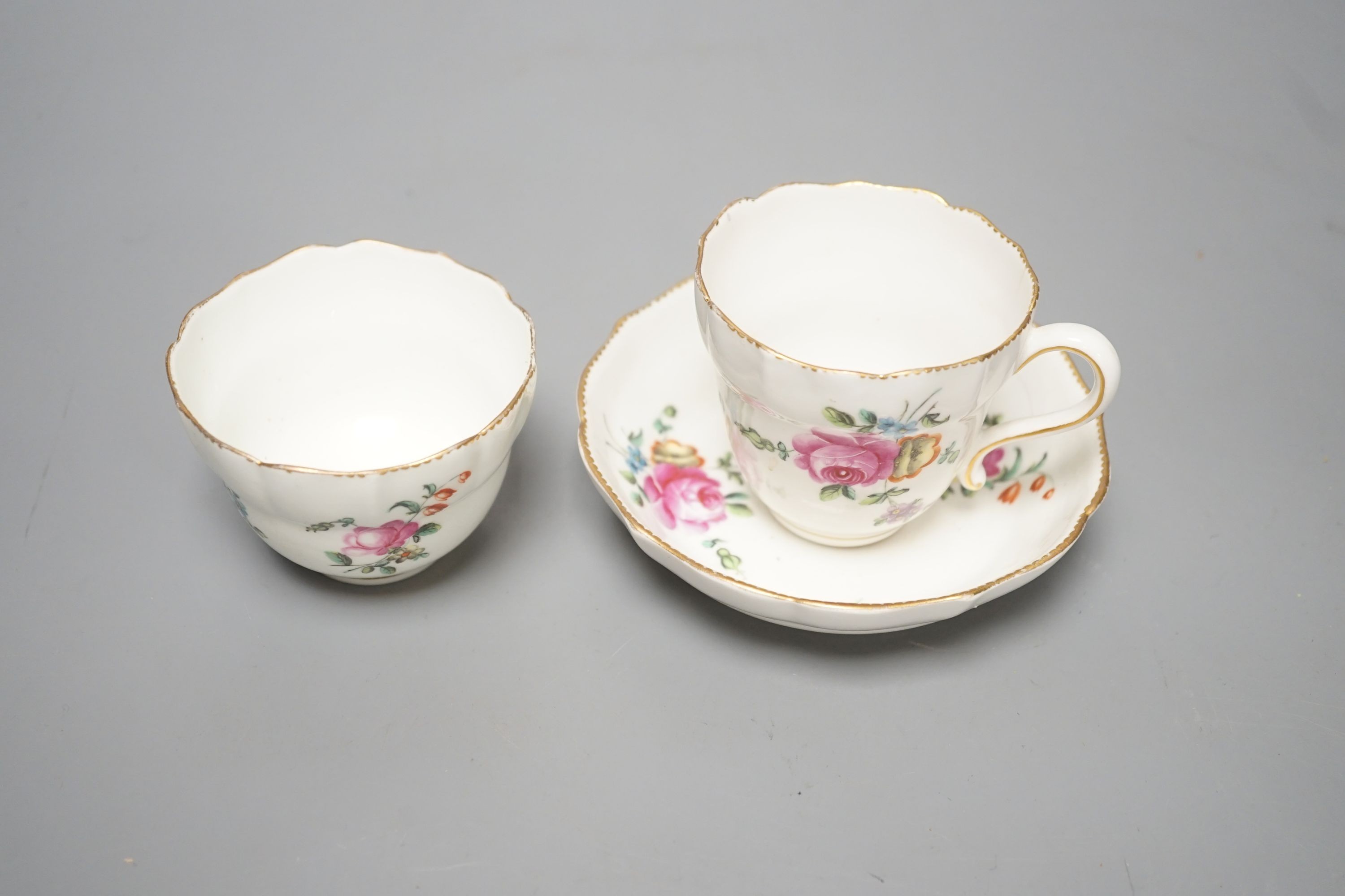 A Chelsea-Derby coffee cup, tea bowl and saucer painted with sprays and sprigs of flowers, c.1775, diameter 12cm